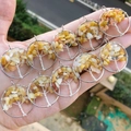 Handmade silver wire tree of life pendant with yellow gemstone chips on a hand - Yellow Aventurine