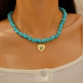 Bohemian turquoise bead necklace with a hammered gold heart pendant on a female model - Hammered Heart Irregular Beaded Style (10804)
