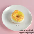 Bright yellow artificial PU donut with pink icing, orange flower, and 7cm diameter size - Yellow (Pearl Donut)