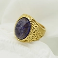 Macro shot of gold-plated Viking ring featuring a large oval purple gemstone with scrollwork - US 7 / Gold + Purple Stone