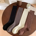 Solid color combed cotton knee high socks in black, gray, cream, and brown rib knit - One Size / Random Color