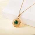 Vintage gold stainless steel necklace featuring a circular green malachite inlay pendant - Spiral Relief Round Malachite Style (137603)