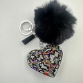 Detail of leopard print heart keychain with black faux fur pompom and rhinestone Love motif - Multi-color