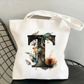 Close-up of canvas tote bag with floral letter T print on a black metal chair - Letter T / 35*40cm
