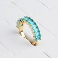 Macro detail of gold plated ring with rectangular blue gemstones on display stand - Adjustable Open / Sky Blue