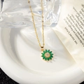 Detail of sunflower pendant with olive green gemstones and gold chain on vintage paper - Necklace (with Lips Chain) / Green