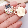Detail of enamel black cat tea cup charm showing front colorful pattern and back metal texture - Flower Cup Black Cat - Gold Base