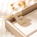 Puffy gold letter E pendant necklace with sparkling cubic zirconia on jewelry box - Letter E (18k Gold + Bead Chain)