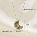 Detail view of gold moon pendant with natural stone and precise size measurements - Labradorite