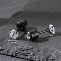 Detailed macro view of 4mm cubic zirconia stud earrings with textured black screw backs - 4mm / Black