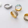 Detailed macro view of colorful checkerboard enamel patterns on geometric rings - US 7 / Black and White Striped Enamel