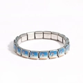 Detail of stainless steel link bracelet featuring coastal beach hut enamel patterns - Seaside Cottage Painting (Style 8)