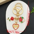 Detail view of gold keychain with red enamel roses and hollow heart love pendant - Red Glitter Rose LOVE Heart Style (ER1286)