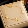Gold plated stainless steel bracelet with five-petal flower charms on jewelry display pad - Gold Five-Petal Flower Style (B1278)