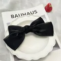 Barrette à cheveux élégante avec grand nœud en soie noire et fermoir à ressort pour femme - Noir Glacé