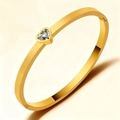Elegante brazalete de acero de titanio dorado con un circón brillante de corazón - Dorado
