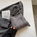 Gray faux suede fringe crossbody bag with white embroidery on a minimalist background - Gray