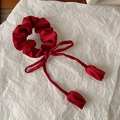 Detail of wine red satin scrunchie with long ribbons and tulip flower bud pendants - Red