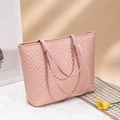Pink quilted tote bag with wavy patterns on a marble surface with calla lily decoration - Pink