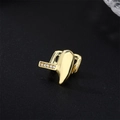 Single gold plated hip hop grillz with white zircon inlay on a dark background - Fangs / Gold