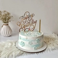 Golden acrylic Happy Birthday cake topper on a blue and white snowflake cake - Design No.6 / Gold