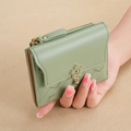 Green compact bifold wallet with diamond quilted stitching and floral embroidery accents - Green