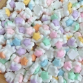 Macro shot of colorful star-shaped acrylic beads for DIY nail art and hair accessories - Star Cloud