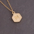 Macro shot of gold hexagon pendant with hammered texture and engraved letter N - Letter N (14#N)