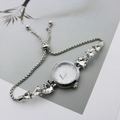 Detail of silver bracelet watch featuring heart-shaped crystals and a minimalist dial - Silver White