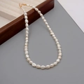 Elegant baroque freshwater pearl necklace with gold clasp on wooden jewelry tray - 6-7mm Baroque Pearl Necklace