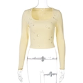 Detail of light yellow ribbed knit top featuring decorative transparent water drop rhinestones - S / Yellow