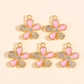 Detailed view of pink enamel flower charms with crystals for DIY jewelry making - Pink