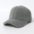 Close-up detail of dark grey sherpa baseball cap showing its fuzzy texture and curved brim - Army Green