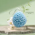Blue honeycomb bath sponge with soft texture and white hanging cord on stone surface - Ocean Blue