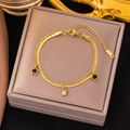 Double-layered 18k gold plated titanium steel star bracelet with black and white inlays - Gold Black and White Star Bracelet (SLE60)