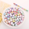 Colorful acrylic skull-shaped beads in a white ceramic bowl for DIY craft jewelry - 10x12mm White With Colored Skull (50pcs)