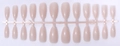 Detail of 24-piece nude pink almond-shaped press-on nails on a plastic sheet - Translucent Nude Pink (SD-07)