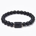 Detailed close-up of matte black onyx bead bracelet featuring a rose gold Pisces zodiac charm - Pisces
