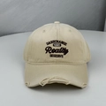 Detailed view of distressed beige baseball cap featuring black letter embroidery design - One Size (58-60cm) / Beige