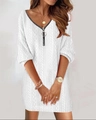 Detailed close-up of V-neck knitted dress featuring cable knit texture and metal zipper - White