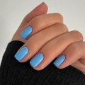 Classic bright blue glossy square oval press-on nails shown on hand with black knit cuff - Light Blue (JP3160)