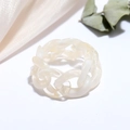 Detail of cream white resin chain link ring on soft silk fabric and dried flowers - Off White
