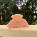 Detailed close-up of a pink floral acetate hair claw clip with golden French lettering - Pink