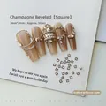 Macro detail of 2mm champagne square bevel cut nail art zircons on ivory textured card - Champagne Square 2x2 (XY-1021)