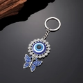 Exotischer Böser Blick Schlüsselanhänger mit funkelndem blauem Strass Schmetterlingsanhänger - Schmetterling Auge