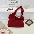 Close-up of deep red wool tote bag showing metal snap button and beige inner lining - Christmas Red