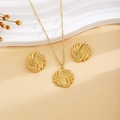 Golden spiral vortex necklace and earrings set displayed on a beige textured background - Gold Vortex Style