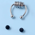 Macro detail of silver magnetic fake nose ring with interchangeable black ball ends - Magnetic Nose Ring with Black Rubber Ball / Steel Color/Black