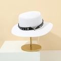 Detail of white straw hat with black leather belt and silver bull head metal emblem - White