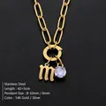Stainless steel lowercase letter M necklace with purple shiny gemstone pendant in gold - Lowercase m